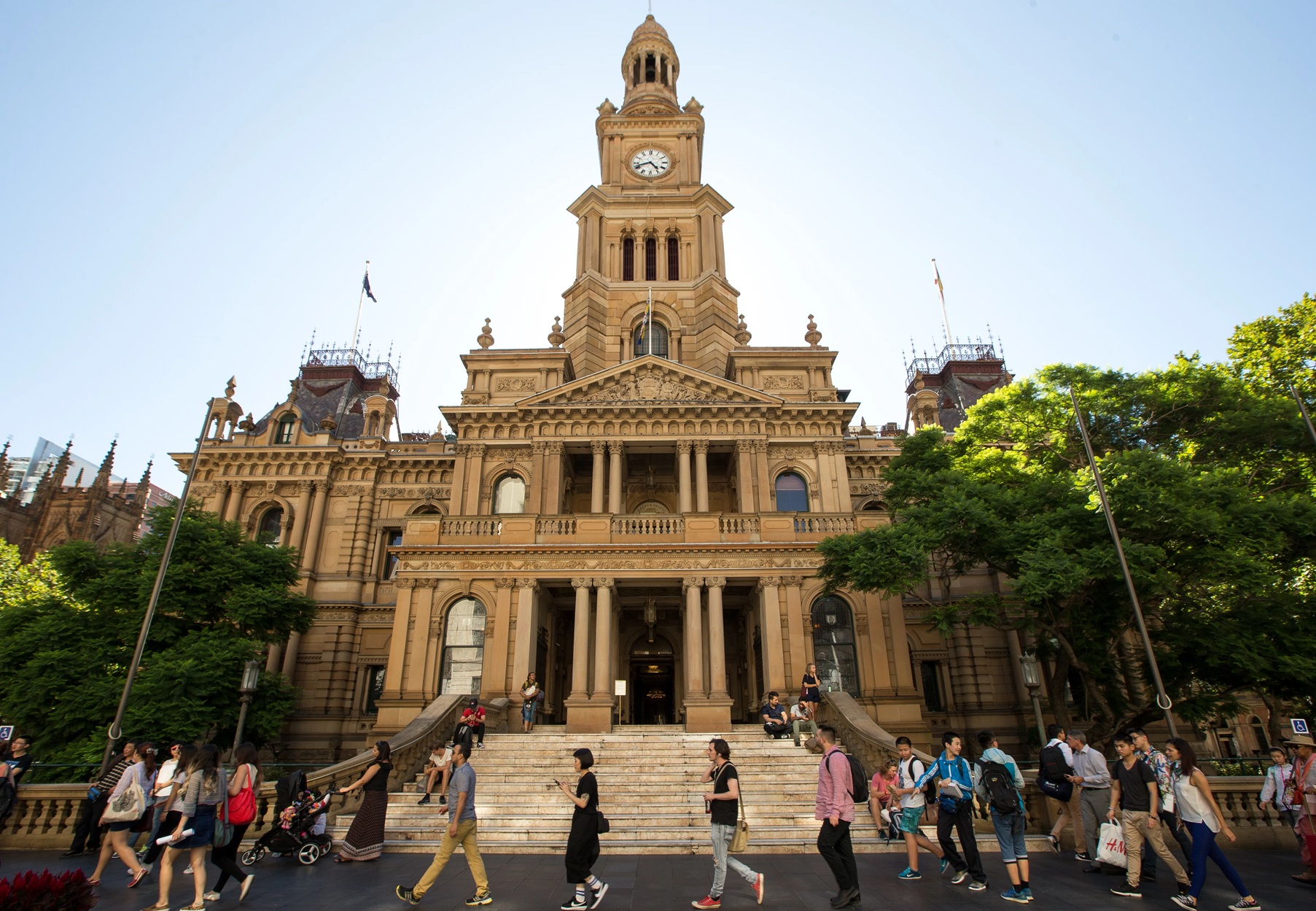 Historic Sydney Town Hall with sandstone facade and clock tower illuminated at night